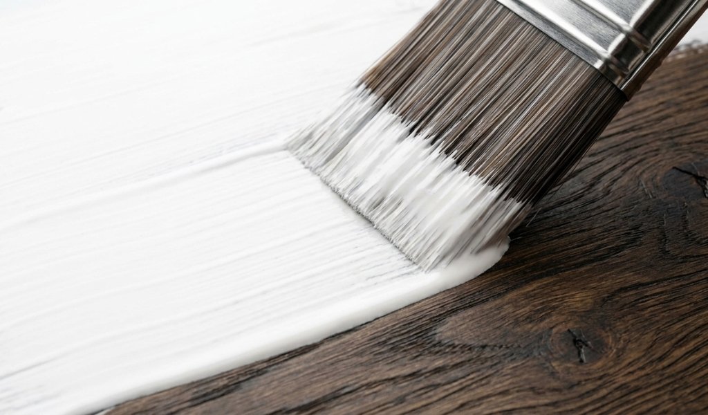 painting a coat of white stain-blocking bonding primer over dark stained wood